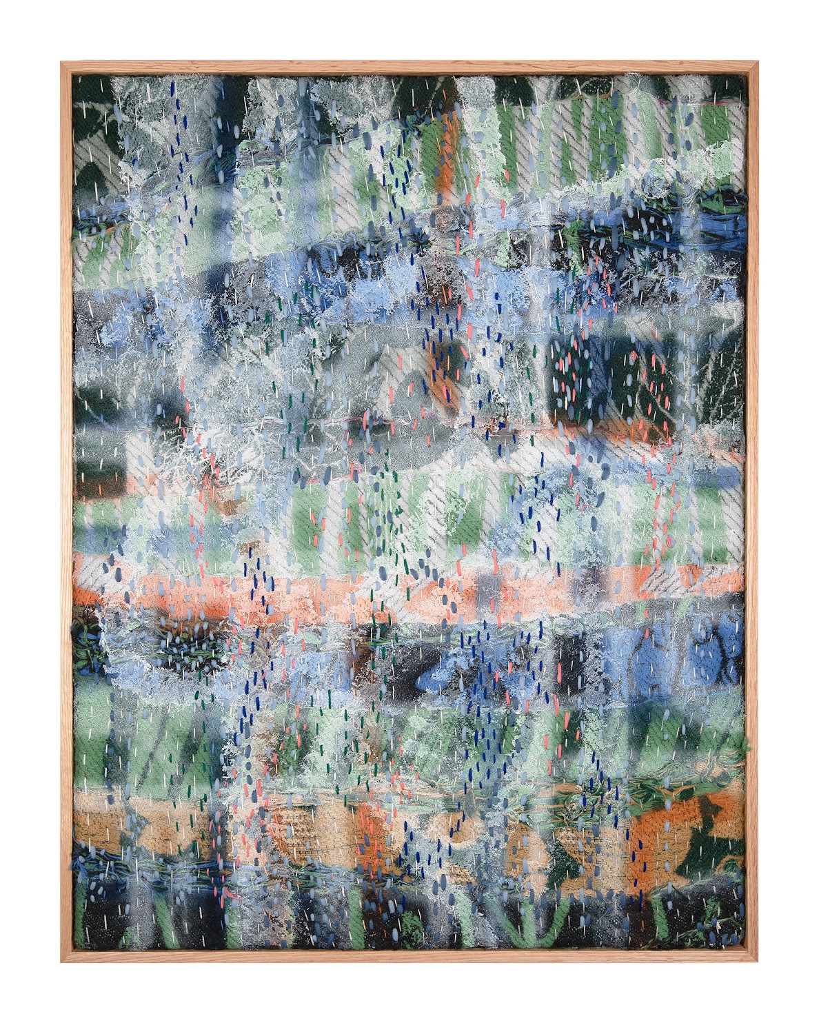 Yuri — an abstract textile painting of layered blue, green and orange woven jacquard remnants under dense sashiko stitching, in a light oak frame